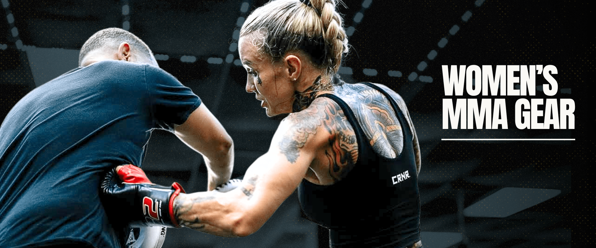 Photo of Combat Corner's Women's MMA Gear. The photo shows CRNR Pro Team Member Taylor Starling using Combat Corner C2 MMA Training Gloves, HMIT Supply Muay Thai Shorts, and Women's Active Bra Tank.